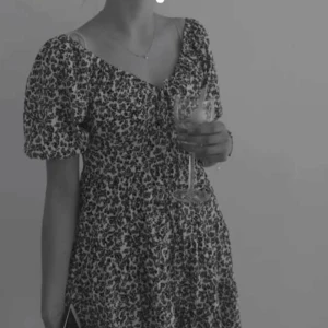 Klänning från bikbok - Super fin klänning från bikbok med svarta blommor på och knytningen på framsidan vid bysten