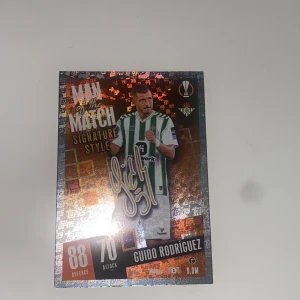 Match Attax fotbollskort - Guido Rodríguez - Säljer ett Match Attax fotbollskort från Topps med Guido Rodríguez i Real Betis Balompié. Kortet är en 'Man of the Match' Signature Style med glänsande detaljer och visar spelarens försvars- och anfallsstatistik. Perfekt för samlare av fotbollskort!