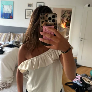 Offshoulder volangtopp i vit❣️ - Snygg offshoulder topp i vit med volang längs hela överkanten. Så snygg och passar till allt! Inga defekter, bara att skriva vid frågor!🩷