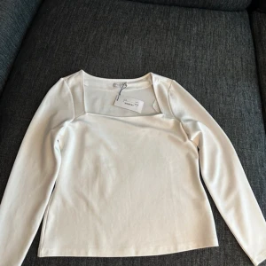 Vit långärmad topp med fyrkantig ringning - Snygg vit långärmad topp  med modern fyrkantig ringning. Oanvänd 💗