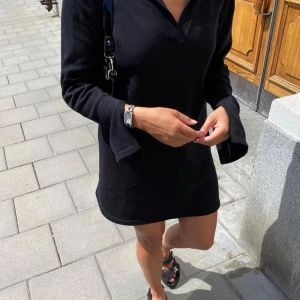Djerf Avenue Getaway dress - En svart stickad långärmad klänning från Djerf Avenue med krage. Klänningen är i superbra skick förutom en tråddragning och ett litet hål under kragen (se bilder), som inte syns när man har på sig den🌸