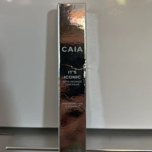 CAIA It's Iconic Satin Radiance Concealer 4C - CAIA It's Iconic Satin Radiance Concealer i nyansen 4C. Kommer i en snygg, fyrkantig förpackning med silvrigt lock. Innehåller hyaluronsyra och vitamin C för extra vård. Perfekt för att täcka ojämnheter och ge en fräsch finish. Bara prövat färgen på handen. Inte på ansiktet! Tvättade händerna innan!!