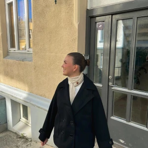 Kappa  - Säljer en svart kappa med dubbelknäppning och bred krage. Jackan har en loose passform och är tillverkad i polyester. Aldrig använd, provar sälja här innan jag skickar tillbaka. Storlek xs/s men passar även m. Nypris 820kr ink frakt, säljes för 600kr. 