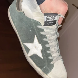 Golden goose skor - Säljer mina golden goose skor som jag har haft ett tag men tagit hand om väl. Otroligt snygg och sällsynt färg. Mockan är i bra kvalitet men bara lite smuts som går att ta bort. Lite sönder på hälarna som ni ser på sista bilden. Nypris ligger på upp mot 7000kr men denna färg är svår att få tag på. Tveka inte på att höra av er!