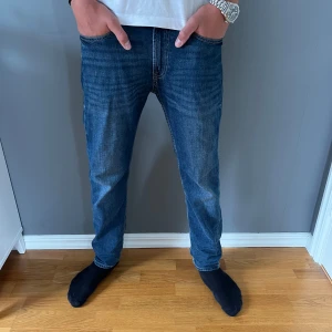 Blå jeans från Dressmann  - Snygga blå jeans från Dressmann i modellen Regular Fit men är som slim flitt ✅jeansen har en stilren look och har fem fickor.