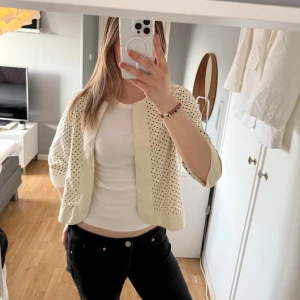 Vit prickig cardigan från Lollys Laundry - Säljer en söt vit cardigan/blud från Lollys Laundry med svarta prickar. Den är i ett  lätt material och tunt material, perfekt över ett linne! Superfint skick!💕
