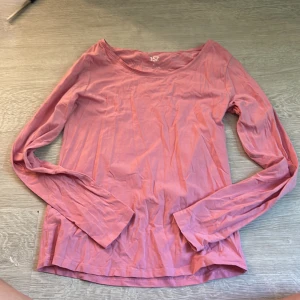 Rosa långärmad tröja från 157 - En basic rosa långärmad tröja från 157 i mjuk bomullsblandning med lite stretch. Tröjan har rund halsringning och en enkel, rak passform som funkar till allt. Perfekt att styla med jeans eller kjol för en chill look.