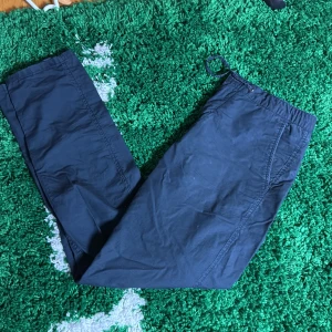 Två par mjukisbyxor med snörning - Säljer två par mjukisbyxor med elastisk midja och snörning. Ena paret är mörkblå och det andra är grå. Båda har raka ben och sidofickor, perfekta för chill dagar eller när du vill vara bekväm. Materialet känns mjukt och lätt mot huden., liknar linnebyxor