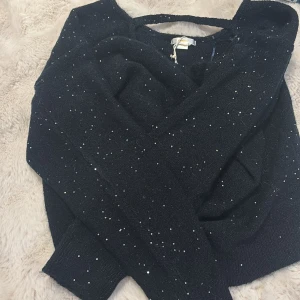 Marinblå  glittrig stickad tröja Gina Tricot - Marinblå  stickad tröja från Gina Tricot med glittriga paljetter över hela tröjan. Mjuk och skön med långa ärmar och ribbade muddar. Perfekt för dig som vill ha lite extra bling i vardagen.