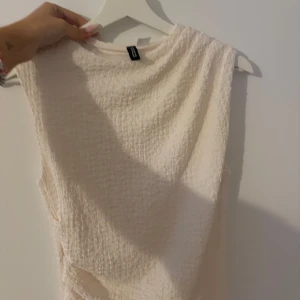 Klänning från h&m - Supersnygg krämvit klänning från H&M med lite detaljer vid magen. Sitter som en smäck! Endast provad!🤍😍 ytterst lite genomskinlig nertill.  skulle rekommendera ljusa underkläder! 