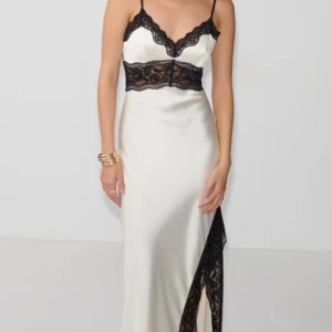 Vit långklänning med svart spets - Säljer denna supersnygga vita långklänningen från Gina Tricot då den inte kommer till användning längre, endast använd 2 gånger med lite trådar som sticker ut vid ryggen. Skriv för fler bilder!