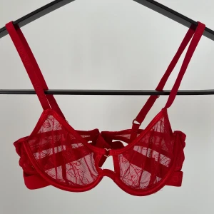 Lounge Underwear BH <3 - Supergullig röd mesh bh från Lounge, storlek 65C. Söta små hjärtan som detaljer. Tror att den eventuellt kan ha blivit tvättad lite för varmt då den blivit lite wonky när den ej sitter på. Fint skick i övrigt <3