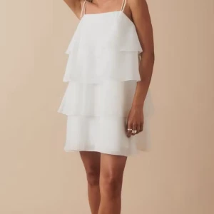 Vit  klänning med volanger - Super fin vit klänning från Gina, använd fåtal gånger, slutsåld online .