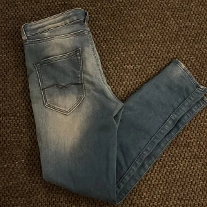 Replay Boy Fit ljusblå jeans - Snygga ljusblå Boy Fit jeans från Replay med klassisk femficksdesign och diskret slitning. Jeansen har smal passform och raka ben, tillverkade i mjukt bomullsmaterial. Perfekta för dig som gillar en avslappnad men trendig look. 