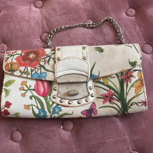Blommig kuvertväska  - Välanvänd men mycket fin! Passar perfekt till sommaren!
