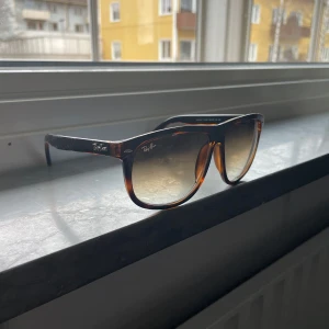 Ray-Ban Boyfriend - Snygga solglasögon från Ray-Ban med en klassisk brun sköldpaddsmönstrad båge och tonade glas. Perfekta för soliga dagar och kommer med ett stilrent brunt fodral. Säljer brillorna då de inte kommer till den användning jag trodde de skulle. Kan gå ner i pris vid snabb affär så hör gärna av er!