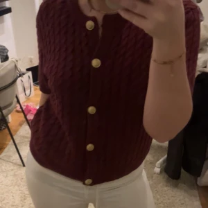 Vinröd stickad kofta med guldknappar - Säljer en snygg vinröd stickad kofta från H&M. Storlek L men sitter jättebra på mig som vanligtvis har storlek xs/s☺️Säljer då den inte kommer till användning längre