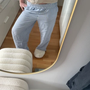 Randiga byxor från Pigalle - Säljer ett par bekväma och stilrena randiga byxor från Pigalle i storlek XS. Byxorna har ett blått och vitt mönster och är perfekta för en avslappnad look. De har en loose passform och är tillverkade i ett mjukt material. Passformen är lös och passar storlek xs-m då jag vanligt vis har m🤞🏻