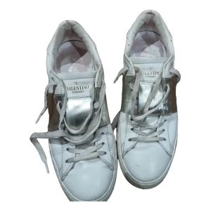Valentino Garavani sneakers i vitt och silver - Snygga Valentino Garavani sneakers i vitt med silverdetaljer. Skorna har klassisk snörning och en stilren design som passar perfekt för en trendig look.