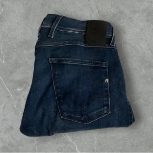 Mörkblå jeans från Replay - Snygga mörkblå jeans från Replay med en klassisk femficksdesign. Storlek w30/l32.De har en slim passform och är tillverkade i ett bekvämt denimtyg. Perfekta för en stilren look. Priset kan gå ner vid snabbaffär. Ordinarie pris vid 1499 men hos mig 700kr
