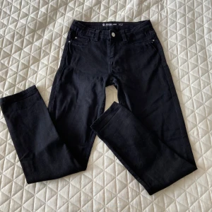 Svarta superstretch-jeans 152 - Svarta superstretch-jeans från Denim, modell Jegging Jade. Byxorna har klassisk femficksdesign, smal passform och normal midja. Materialet är mjukt och stretchigt för extra komfort.