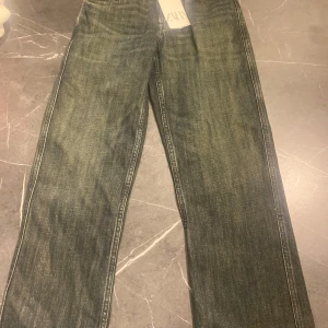 Zara relaxed fit jeans blå 34/28 - Snygga relaxed fit jeans från Zara i klassisk blå tvätt. Jeansen har rak passform och är tillverkade i slitstarkt denimtyg. Perfekta för en chill och avslappnad look. Storlek 34/28.