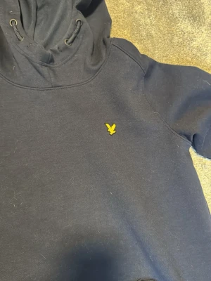 Lyle&Scott tröja - En mörkblå lyle&scott hoodie gjort i skönt material. Gjord för 12-13 åringar men kan passa på upp till 13-14 Max 15. 