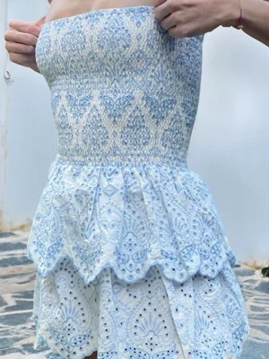 Subdued klänning - Supersöt axelbandslös kortklänning i ljusblått och vitt med broderade detaljer och volang ifrån subdued. Jätte fin klänning att ha i sommar.