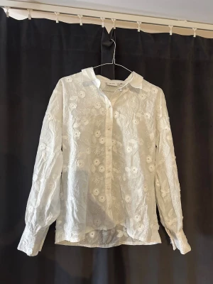 Vit damskjorta med blommor - Säljer denna jättesöta skjorta från VILA. Endast använd 1 gång så den är i mycket bra skick❤️ 