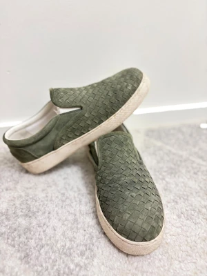 Olivgröna slip-on Bottega Veneta i mocka - Säljer ett par Olivgröna Bottega Veneta sneakers i mocka och vit platt sula. Säljer dessa pga för stor storlek. Storlek 42 men kan passa 43. Använt dessa 1 gång och nu till säljes. Pris kan diskuteras vid snabbaffär
