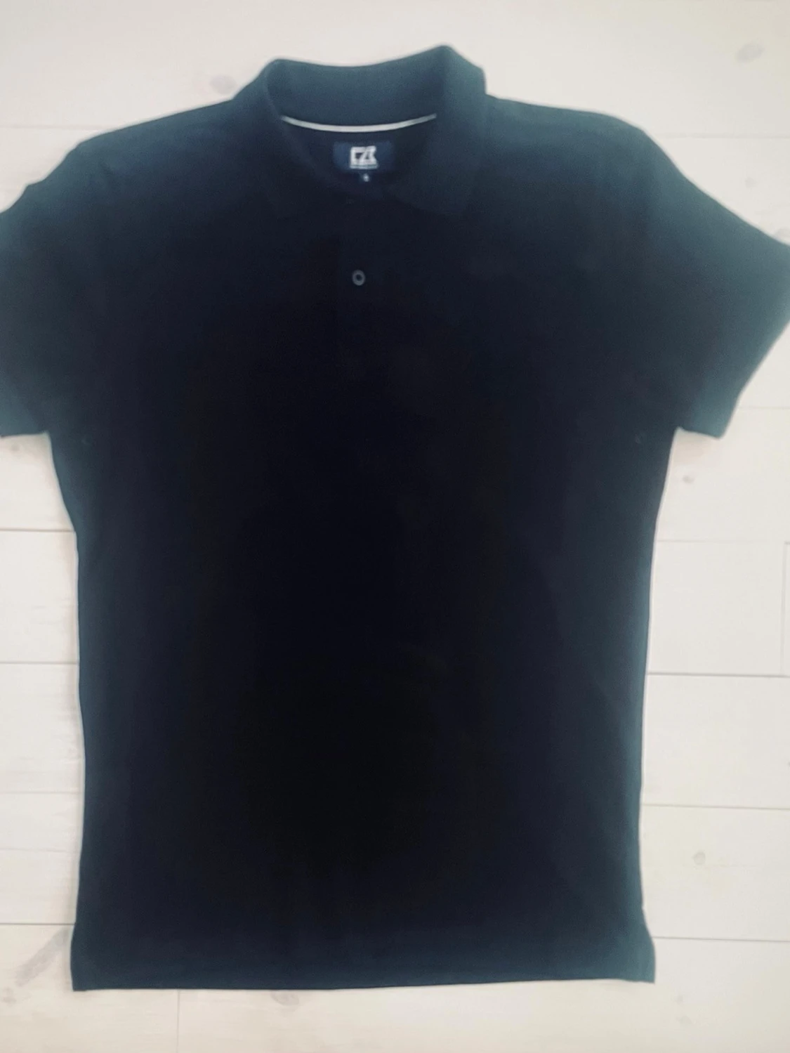 Svart piké från Cutter & Buck