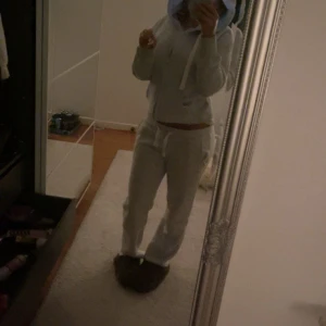 Vit hoodie med dragkedja och huva - Mysig vit hoodie med dragkedja och huva. Tröjan har snörning i halsen och är långärmad, perfekt för chill dagar. Passformen är normal och materialet känns mjukt och bekvämt mot huden.