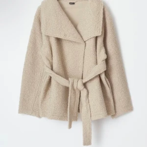 Beige teddyjacka med bälte - Säljer en beige teddyjacka från Gina Tricot med bred krage och knytbälte i midjan. Jackan har lång ärm och en mjuk, fluffig yta som ger en chill vibe. Perfekt för att hålla sig varm och snygg under höst och vinter. Passar dig som gillar oversized look. Köpt för 599kr i mycket bra skick! 
