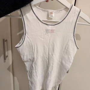 Ribbat linne  - Ribbat linne med en broderad detalj framtill. Fungerar för en xs i storlek, då den är stor i storleken.