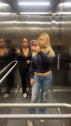 Mörkblå croppad pufferjacka - Säljer en mörkblå croppad pufferjacka med quiltade paneler och dragkedja framtill. Jackan har lång ärm och en loose passform som ger en chill vibe. Perfekt för dig som gillar streetstyle och vill ha något som sticker ut.