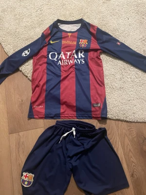 FC Barcelona Neymar Jr långärmad matchtröja - Säljer en officiell FC Barcelona långärmad fotbollströja med Neymar Jr och nummer 11 på ryggen. Tröjan har breda marinblå och röda ränder, gula tryck och Qatar Airways samt UNICEF-loggor. Materialet är lätt och andas, perfekt för träning eller match.  