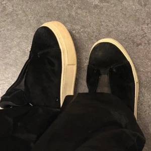 Svarta Eytys sneakers med platåsula - Säljer ett par svarta Eytys sneakers i mocka med chunky beige platåsula. Skorna har en minimalistisk design med rund tå och lila hälflik. Perfekta för dig som gillar streetstyle och vill ha något som sticker ut.