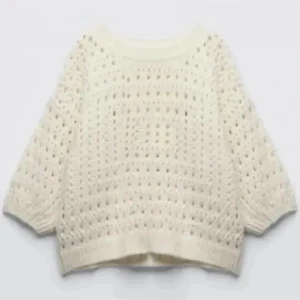Vit stickad tröja med hålmönster - Säljer en vit stickad tröja med hålmönster och rund hals. Tröjan har trekvartsärmar och ribbade muddar vid ärmslut och nederkant. 