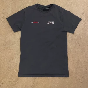 Svart t-shirt Supply & Demand S - Cool svart t-shirt från Supply & Demand med tryck på både bröstet och ryggen. Ryggen har en stor grafisk ängel och texten 'SUPPLY Demand'. Skön passform och tillverkad i mjuk bomull. Perfekt för dig som gillar streetwear vibes(Pris kan diskuteras).