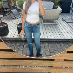 Blå raka jeans från Zara - Säljer ett par klassiska blå Zara jeans med rak passform och medelhög midja. Jeansen har fem fickor, dragkedja och knapp framtill. Perfekta för dig som gillar en avslappnad men ändå snygg stil. Materialet är slitstarkt jeans i bomull.