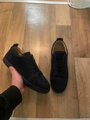 Mörkblåa sneakers i mocka - Stilrena svarta sneakers med rund tå och snörning. Skorna har en ovandel i mocka och en platt sula, vilket ger en clean och modern look. Perfekta för dig som gillar minimalistisk stil. Skicket 9/10 nästan nya förutom att snöret är lite trasig storlek 44 passar43