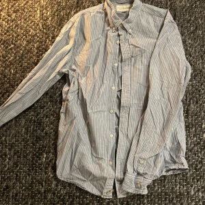Denim and supply skjorta - Snygg randig skjorta från Denim & Supply Ralph Lauren i blått och vitt. Klassisk button-down krage, långa ärmar och knäppning framtill. Skjortan är i mjuk bomull och har en relaxed vibe, perfekt till jeans eller chinos.
