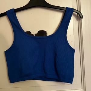 Blå ribbad linnetopp - Säljer en snygg blå linnetopp med ribbad struktur. Toppen är croppad