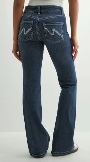 Blå bootcut jeans med broderade fickor - Snygga populära blå bootcut jeans med coola broderade detaljer på bakfickorna från Nelly, Storlek 32. Knappt använda då dom är för långa för mig men kommer fler bilder inom en stund! Kan vara lite smått slitna längst ned men inget allvarligt eller som man tänker på.🥰ordinarie pris:699kr säljer för 500kr