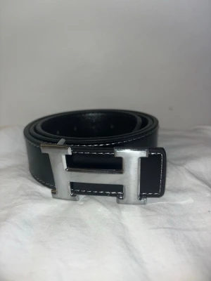 Svart bälte med silver spänne - Jag säljer ett helt nytt svart läder bälte med silver spänne. Väldigt enkelt och fångar mångas blickar.