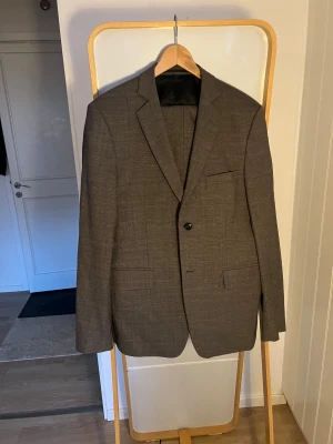 Kostym Bruun Bazar - Snygg kostym Bruun Bazar i fantastisk gråmellerad kvalité, knappt använd och Stl 50