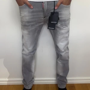 Dsquared2 Slimfit Jeans gråa  - Ett par väldigt fina gråa slimfit jeans från dsquared med slitningar | Storlek 33, 41 cm i midjan och 101 cm i längd | Fraktar samma dag om köp sker innan 22:00