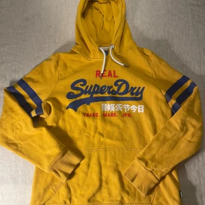 Gul Superdry hoodie med tryck - | märke: Superdry | plagg: Hoodie | skick: 9/10 | storlek: EU 42/XS| nypris: 1500kr | mitt pris: 349kr | färger: Gul | pris kan diskuteras | hör av dig vid minsta fråga eller fundering // LeClosMatteo