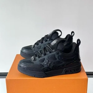 Louis Vuitton LV Skate-sneaker - Louis Vuitton LV Skate-sneakers i svart. Använda i cirka en månad och i mycket gott skick. 100 % äkta med kvitto som kan visas vid önskemål. Stilrena och bekväma, perfekta för både vardag och speciella tillfällen.