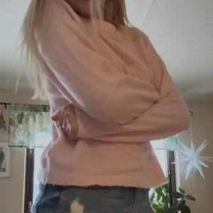 Ljusrosa stickad tröja - Mysig ljusrosa stickad tröja med rund hals och långa ärmar. Tröjan har en enkel och clean look utan mönster eller detaljer, perfekt att matcha med jeans. Materialet är mjukt och ger en chill vibe.